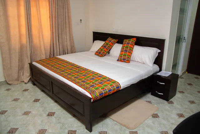Guest bedroom with colourful Ghanaian textile accents