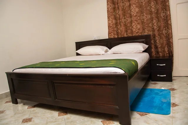 Guest bedroom with green textile accents
